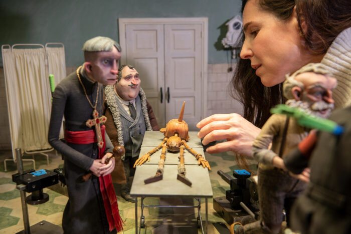Close up photo of an artist working on Pinocchio puppets
