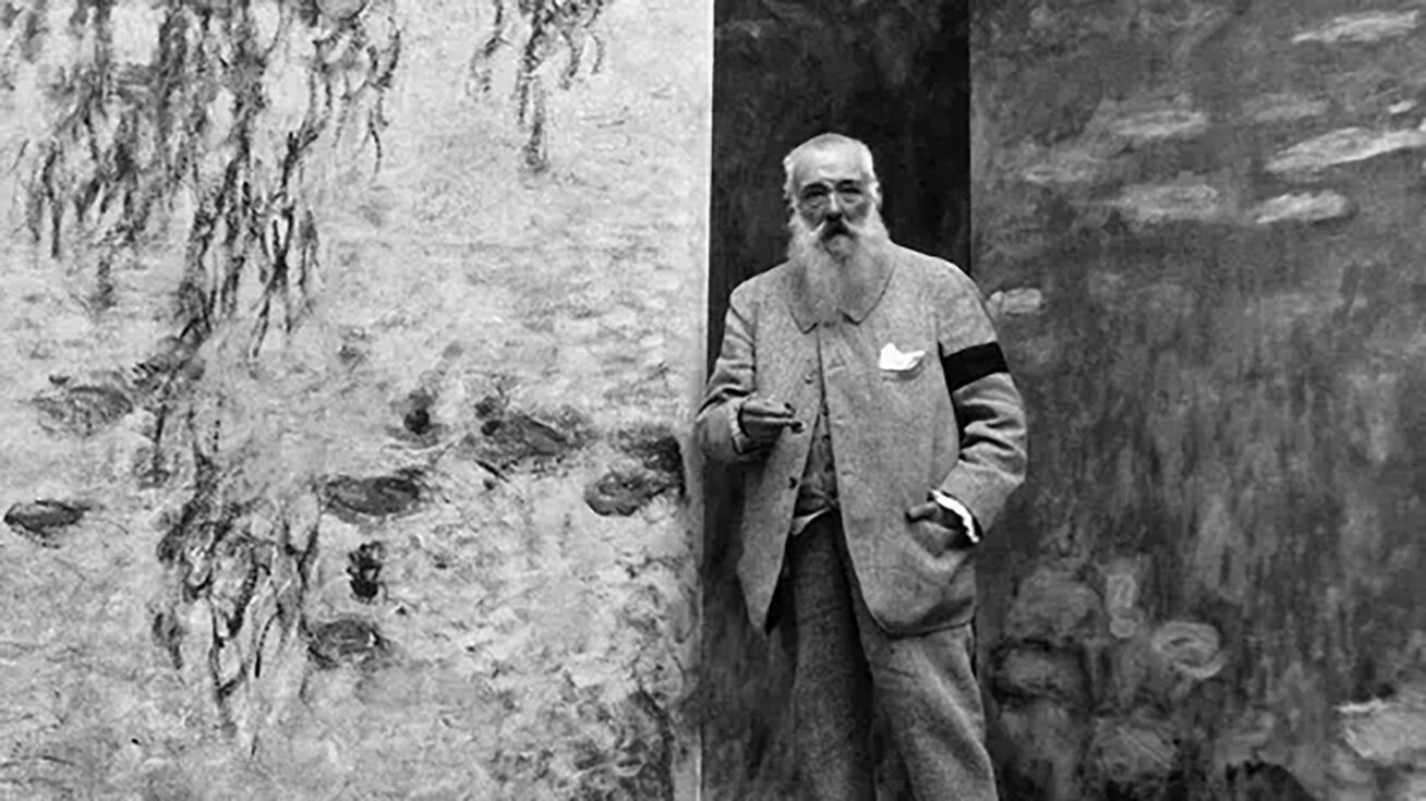 A person standing between two large paintings.